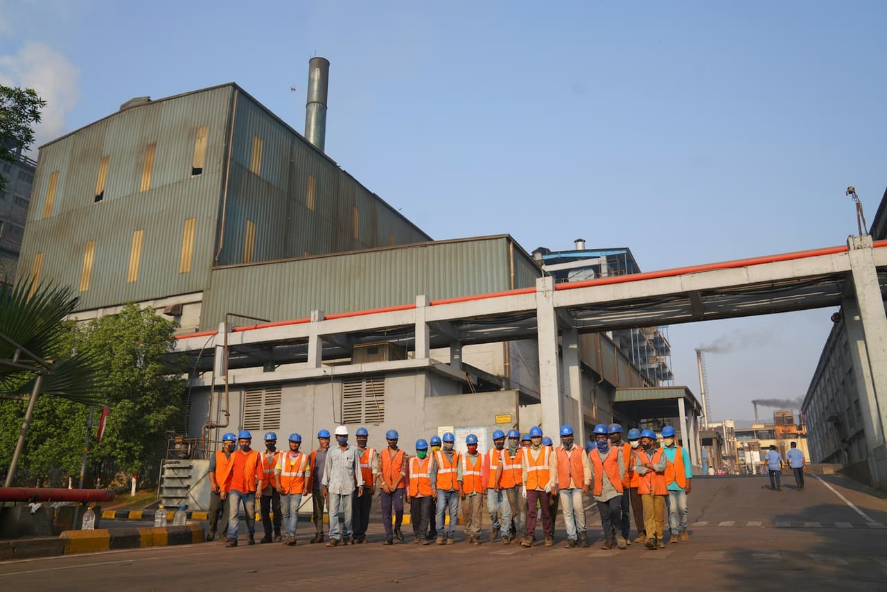 A factory team in safety vests
